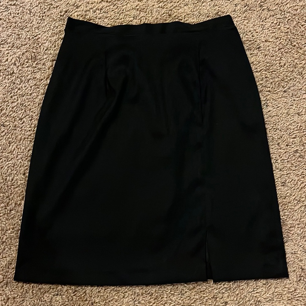 Plain black knee length skirt with zippered back, size 6